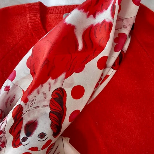 red spotty silk scarf and red sweater